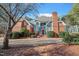 Charming two-story home featuring a red brick facade, blue accents, and a well-manicured front yard at 725 Thompson Rd, Garner, NC 27529