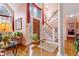 Grand foyer with a staircase, chandelier, arched window, and hardwood floors offering a bright and inviting entrance at 725 Thompson Rd, Garner, NC 27529