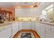 Bright kitchen featuring ample cabinet space, countertops, and hardwood floors at 725 Thompson Rd, Garner, NC 27529