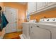 Functional laundry room with washer, dryer, utility sink, and ample storage space at 725 Thompson Rd, Garner, NC 27529