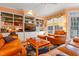 Bright living area with a leather sofa, built-in shelving, and natural light at 725 Thompson Rd, Garner, NC 27529