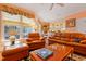 Inviting living room with leather furniture, windows, and an open floor plan at 725 Thompson Rd, Garner, NC 27529