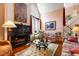 Cozy living area featuring hardwood floors, a fireplace, and a glass coffee table for stylish entertaining at 725 Thompson Rd, Garner, NC 27529