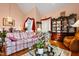 Cozy living room featuring a floral sofa, hardwood floors, and a glass coffee table at 725 Thompson Rd, Garner, NC 27529