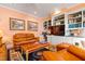 Comfortable den with a leather sofa, built-in shelves, and a mounted television at 725 Thompson Rd, Garner, NC 27529