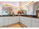 Bright primary bathroom with double sinks, large mirrors, and great lighting at 725 Thompson Rd, Garner, NC 27529