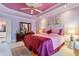 Bright bedroom featuring an elegant bed, ceiling fan, and adjoining bath at 725 Thompson Rd, Garner, NC 27529