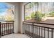 Cozy balcony with black metal railing overlooking landscaped greenery and mature trees at 7250 Hwy 751 # 2109, Durham, NC 27707