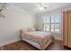 Cozy bedroom with hardwood floors, plantation shutters, and a ceiling fan providing a relaxing retreat at 7250 Hwy 751 # 2109, Durham, NC 27707
