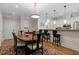 Open dining area features a wood table with seating for six, overhead lighting and barstool seating at the counter at 7250 Hwy 751 # 2109, Durham, NC 27707