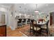 Open dining area featuring a breakfast bar, hardwood floors, and stylish lighting fixtures at 7250 Hwy 751 # 2109, Durham, NC 27707