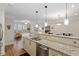 Kitchen with granite countertops, stainless steel appliances, and open floor plan leading to the living room and dining areas at 7250 Hwy 751 # 2109, Durham, NC 27707