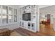 Bright living room features custom built-ins, hardwood floors, and shuttered windows for a cozy and inviting space at 7250 Hwy 751 # 2109, Durham, NC 27707