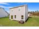 Rear exterior view of home with a well-kept lawn and a visible air conditioning unit at 809 Rhino Bnd, Oxford, NC 27565
