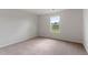Comfortable carpeted bedroom filled with natural light from the large window at 809 Rhino Bnd, Oxford, NC 27565