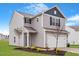 Charming two-story home with gray siding, a well-manicured lawn, and an attached two-car garage at 809 Rhino Bnd, Oxford, NC 27565