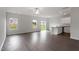 Bright living space featuring wood floors, a ceiling fan, natural light, and a view to the kitchen at 809 Rhino Bnd, Oxford, NC 27565