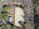 Aerial view of horse arena with adjacent buildings and lush surrounding trees at 8809 Farrington Mill Rd, Chapel Hill, NC 27517
