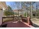 Wooden back deck with outdoor seating and umbrella; the perfect spot for enjoying the backyard view at 8809 Farrington Mill Rd, Chapel Hill, NC 27517