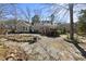 Back exterior view of home featuring back deck, seating, plants and natural backyard with trees at 8809 Farrington Mill Rd, Chapel Hill, NC 27517