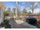 Outdoor space with a brick paver patio, seating, and a charcoal grill under a privacy fence at 8809 Farrington Mill Rd, Chapel Hill, NC 27517