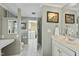 Bathroom with a double vanity and mirror, and door leading to the toilet and laundry room at 8809 Farrington Mill Rd, Chapel Hill, NC 27517