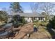 Charming front yard with a traditional-style home, manicured lawn, and mature trees surrounding the property at 8809 Farrington Mill Rd, Chapel Hill, NC 27517