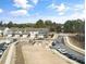 An aerial view showcases new construction townhomes with a community gathering area at 1000 Pyrenees Way, Cary, NC 27519