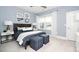 Comfortable bedroom with blue accents, natural light, and stylish decor creating a relaxing atmosphere at 1000 Pyrenees Way, Cary, NC 27519