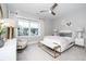 Cozy bedroom with soft lighting, white bedding, and a comfortable bench for a relaxing retreat at 1000 Pyrenees Way, Cary, NC 27519