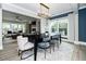 Elegant dining room with modern decor, open floor plan to the living area, and large windows at 1000 Pyrenees Way, Cary, NC 27519