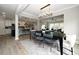 Open-concept dining area showcasing stylish lighting, wood floors, and seamless transition to the kitchen at 1000 Pyrenees Way, Cary, NC 27519