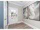 Bright foyer with a wood-look floor, decorated with art, and a glass-paneled door at 1000 Pyrenees Way, Cary, NC 27519