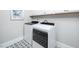 Bright laundry room features modern washer and dryer, stylish tile floor, and ample storage at 1000 Pyrenees Way, Cary, NC 27519