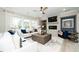Elegant living room featuring a white sofa, modern fireplace, and large windows for natural light at 1000 Pyrenees Way, Cary, NC 27519