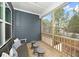 Relaxing screened porch with comfortable seating and views of the surrounding trees and neighborhood at 1000 Pyrenees Way, Cary, NC 27519