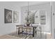 Modern dining room featuring a statement light fixture, a stylish rug, and views of the neighborhood at 1007 Hundley Pl, Durham, NC 27701