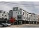 Modern townhome exterior with gray and white facade, featuring multiple levels and street parking at 1007 Hundley Pl, Durham, NC 27701