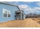 Home's backyard with screened porch and view of the surrounding natural landscape at 1009 Grey Flint Pl, Mebane, NC 27302