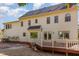 Back exterior featuring a deck, light colored siding, and multiple windows offering natural light at 101 Rustic Wood Ln, Cary, NC 27518