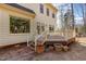 View of a house with a wooden deck, patio, and a backyard with mature trees at 101 Rustic Wood Ln, Cary, NC 27518