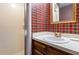 A bathroom featuring red plaid wallpaper, vanity, shower, mirror and golden faucet at 101 Rustic Wood Ln, Cary, NC 27518