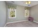 Bright bedroom with two windows featuring decorative valances and neutral colored walls and carpet at 101 Rustic Wood Ln, Cary, NC 27518