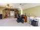 This bonus room has two built-in bookshelves, a ceiling fan and neutral colored carpet at 101 Rustic Wood Ln, Cary, NC 27518