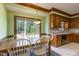 Bright eat-in kitchen featuring a large window with backyard views and wooden cabinets at 101 Rustic Wood Ln, Cary, NC 27518