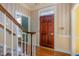 Welcoming foyer with a wooden front door, hardwood floors, staircase and natural light at 101 Rustic Wood Ln, Cary, NC 27518