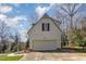 Detached two-car garage with white siding and an A-frame roof, situated behind the main home at 101 Rustic Wood Ln, Cary, NC 27518