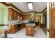 Traditional eat-in kitchen with a center island, stainless appliances, wooden cabinets, and tile floors at 101 Rustic Wood Ln, Cary, NC 27518