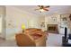 Inviting living room with a brick fireplace, built-in bookshelves, and comfortable leather seating at 101 Rustic Wood Ln, Cary, NC 27518