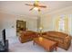 Spacious living room featuring a cozy seating arrangement, neutral carpet, and natural light at 101 Rustic Wood Ln, Cary, NC 27518